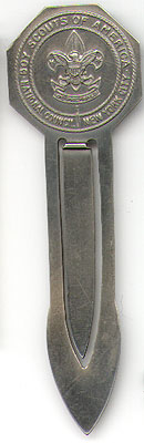 This bookmark was made in the US by The Robbins Co. for the Boy Scouts of America. The top has the fleur de lis Boy Scouts symbol surrounded by the words "Boy Scouts of America National Council New York City". The card that it came with says "Tis but a simple marker, Yet your place t'will always keep, And show the place where you left off When you .......... dozed .... off ....... to ...... sleep." The date is 1950 - 1960.