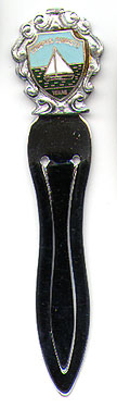 This bookmark was made in the US by an unknown manufacturer. It is a souvenir of Corpus Christi, Texas. It is made of enamel and chrome. The top is a picture of a sail boat in a shield. Date is 1990 - 1998.