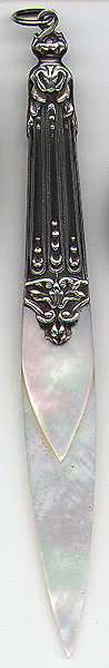 This bookmark was made in France circa 1890 - 1900. It is  made of silver with mother of pearl blades. The silver has an art nouveau design. The silver is unmarked.