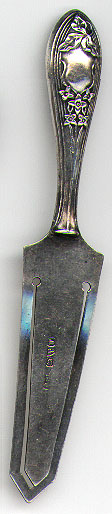 This bookmark was made at Halifax in Yorkshire, England in 1922 by Charles Horner. It is in the shape of a pie cutter with an Edwardian design on the handle. It is marked with the Chester hallmarks for 1922.