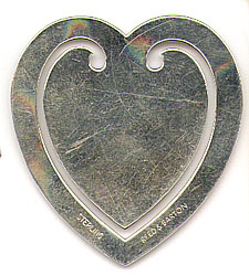  This bookmark was made in the US by Reed & Barton. It is marked Reed & Barton Sterling. It is in the shape of a heart and is very simple. The date is 1970 - 1980.    