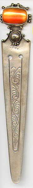  This bookmark was made in Europe. It is large and heavy and was also used as a letter opener. It has a large piece of amber or agate at the top. It is marked 925 on the back. The date is 1920 - 1930.    