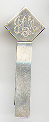 This bookmark was made in the US in 1975 by Leonore Doskow, Inc. It is marked the the makers mark, and Leonore Doskow, Inc. Sterling. It is a simple bookmark with a diamond shape top where someones initals are.