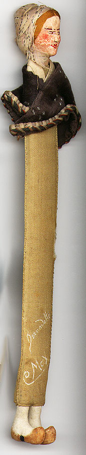  This bookmark was made in the US by an unknown manufacturer. It is a doll bookmark with a velvet cape. The front is marked Bernadette and Max. The date is 1875 - 1890.    