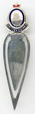  This bookmark was made in the US as a souvenir for British Guiana. It is marked sterling on the back. The top has an enamel picture of a tall sailing ship and "British Guiana". The date is 1950 - 1960.  