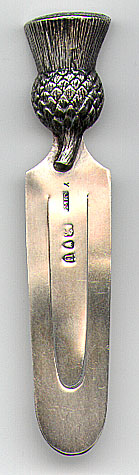 This bookmark was made in England by SM&Co. It is a figural of a thistle on top. It is marked with the London city mark and the date letter "U" for the year 1895.