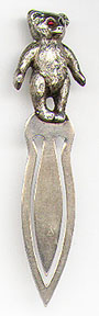 This bookmark was made in the US by Unger Bros. It is marked with the manufacturers mark of an interlaced U and B surrounded by Sterling 925 Fine. It is a figural teddy bear on top with ruby eyes. The date is 1900 - 1910.