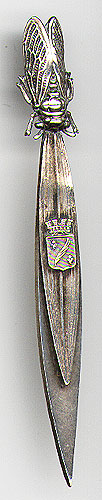  This bookmark was made in France between 1900 and 1910. It is made of some kind of white metal (possibly low grade silver). It has a cicada fly figural on top and a shield for Cannes on the top blade. The back is inscribed Cannes.  