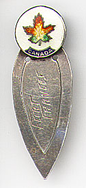 This bookmark was made in Canada by Breadner Co. Ltd. It is marked Sterling B.M. Co. on the back. The top is a round white enamel piece with a multicolored maple leaf and "Canada" underneath it. The middle blade is inscribed "Fort Frances". The date is 1940 - 1945.
