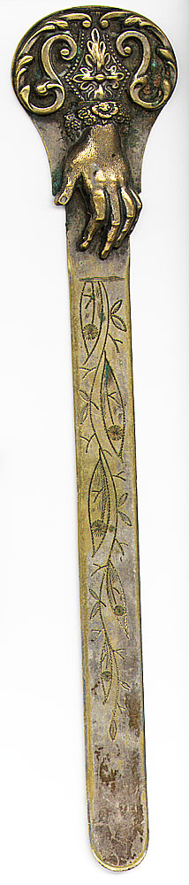  This bookmark was made in the US between 1870 - 1900. It is a very large bookmark with a figural hand as the top blade. It was most likely used as a letter opener. It is made of brass with some remnants of silver plating.   