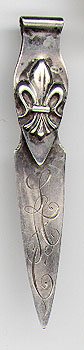 This bookmark was made in the US by the Whiting Manufacturing Co. of New York. It has a fleur de lis on the top blade. The date is 1895 - 1904.