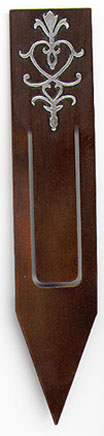  This bookmark was made in the US by  Heintz Art Metal Shop. It is bronze with a dark brown patina and a design with a silver overlay. This is from the Arts and Crafts period. The date is 1910 - 1930.   