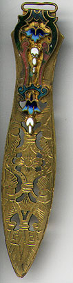  This bookmark was made in France between 1890 - 1910. It is made of bronze d'ore and is known as a Battersea style. It has colorful enamel on the top blade and a cutout design on the bottom blade.  