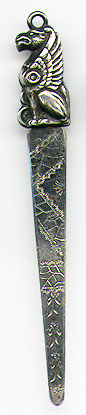  This bookmark was made in the US by an unknown manufacturer. It is unmarked but seems to be sterling. It has a figural griffin on the top and the blade has a scribed design. The date is 1900 - 1910.  
