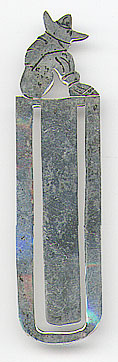This bookmark was made in Mexico in the 1980s. It is marked Sterling Mexico and is a figural man sitting with a sombrero.