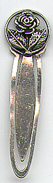 This bookmark was made in a Scandinavian country between 1920 - 1930. It is marked only 900 for 900 fine silver. The top is a circle with a figural flower within it.