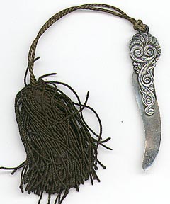 This bookmark was made in the US for Tiffany. It is marked Tiffany & Co. and Sterling. The top blade has an iteresting design and a silk tassel is attached to the top. The date is 1900 - 1920.
