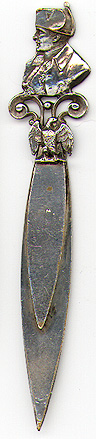  This bookmark was made in France. It is unmarked and is silver plate over brass. The top is a figural bust of Napoleon. The date is 1900 - 1910.  