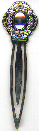 This bookmark was made in the US by Wallace Silversmiths. It is a new bookmark, made in 1998 and is marked Wallace Sterling 925. The top is a sheild with scroll work around the edges.  