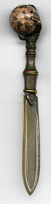  This bookmark was made in Scotland. It is unmarked and is silver plate over brass. The top is a grouse claw gripping a rose quartz marble. The date is 1900 - 1910.  