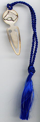 This bookmark was made in the US by J.T. Inman & Co. It is marked Inman Sterling and was made circa 1970 - 1980. It has a horse head on the top with a blue tassel.