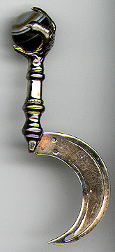 This bookmark has a grouse claw holding a banded agate marble and silver plate blades. It is in the shape of a sickle. It was probably made in a Scotland about 1920 - 1930.  