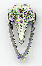 This bookmark was made in the US by F.A. Hermann Co. It is marked Sterling and has the manufacturers hallmark of an "H" enclosed within a triangle. It is a small bookmark with a nice enamel picture of flowers. The date is 1900 - 1910.