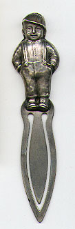This bookmark was made in the US by Unger Bros. It is marked with the manufacturers hallmark and Sterling 925 Fine. It is also marked with a copyright of 1904. It is in the shape of a boy with his hands in his pockets wearing a cap and suspenders.  