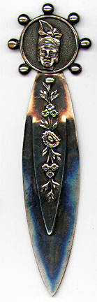 This bookmark was made in France between 1940 - 1960. It is silver plate and has a hallmark on the back which says Toujours Fidele and HQ in the middle. It has a womans head on the and flowers on the top blade.