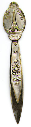 This bookmark was made in France around 1920 - 1930. It is silver plate over brass and is unmarked. It has a figure of the Eiffel Tower on the top and says Tour Eiffel Paris. 