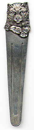 This bookmark was made in the US by Parks Bros. & Rogers. It is marked with the manufacturers hallmark encircled by "Sterling". The top is a very detailed figural cat face and front paws. The date is 1900 - 1910.