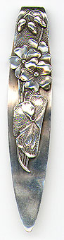 This bookmark was made in the US by Shiebler. It is marked with the famous winged "S" and sterling and 8744. The top blade is a flower with a leaf, stems and buds. The date is 1900 - 1910.