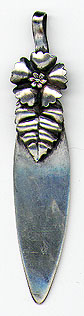 This bookmark was made in the US by Whiting Manufacturing Co. It is marked with the the makers hallmark, sterling and 112. The top blade is a flower and a leaf. The date is 1900 - 1910.