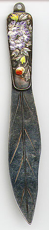 This bookmark was made in China by an unknown manufacturer. It is completely unmarked but has been tested to be sterling. The top blade is a beautiful enamel flower and leaves. The date is 1900 - 1910.