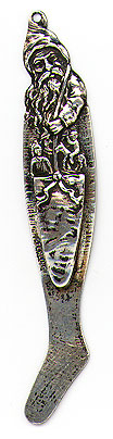This bookmark was made in the US by an unknown manufacturer. It is marked sterling. It is a figural of Santa Claus carring a bag full of toys . The bottom blade is a Christmas stocking. The date is 1900 - 1910.
