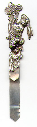 This bookmark was made in the US by an unknown manufacturer. It is marked sterling. It is a figural of rabbit running behind a flower. The date is 1900 - 1910.