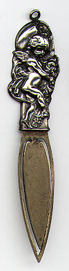 This bookmark is American made by W.H. Saart Co. between 1900 and 1920. It is marked Sterling Front with the makers hallmark. It is an art nouveau cherub holding flowers. The blade is not silver.