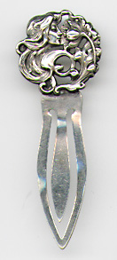 This bookmark was made in the US. It is only marked Sterling on the back. The top is an art nouveau lady head with long wavy hair smelling a large flower. The date is 1900 - 1910.  