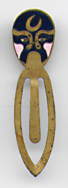 This bookmark was made in China. It is made of tin and enamel paint and has a dark blue and pink Chinese mask on top.  The date is 1960 - 1970.  