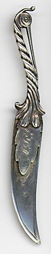 This bookmark was made in the US by Gorham. It is marked with the Gorham hallmark and Sterling and 17. The top is a figural stork and the top blade is a feather. This is from the Autumn 1888 Gorham catalog where they sold 33 different bookmarks. 