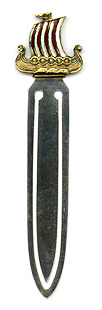This bookmark was made in Norway by an unknown manufacturer. It is marked 925S and a hallmark. The top of the bookmark is an enamel figural of a Norse sailing ship with red and white striped sails. The boat is gold filled or gold plate. The date is 1920 - 1930.