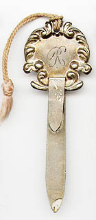 This bookmark was made in the US by an unknown manufacturer. It is marked only sterling on the back. The top is a floral sheath inscribed with the inital R. The date is 1900 - 1910.  