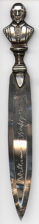 This bookmark is made in England in Birmingham. It has Birmingham hallmarks for 1908. It is a figural of Shakespeare with his signature inscribed on the middle blade.