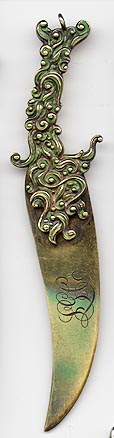 This bookmark is made in the US by Gorham. It is marked with the makers hallmark and B126. The top blade is an art nouveau design with green enamel that almost looks like a fish. The entire bookmark is finished in a gold wash. The date is 1869.