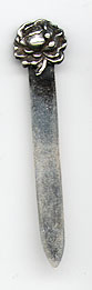 This bookmark was made in the US by La Pierre. It is marked with the makers hallmark and sterling. The top is a figural rose. The date is 1900 - 1910.