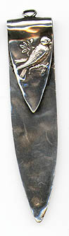 This bookmark was made in the US by Shiebler. It is marked with the Sheibler hallmark, sterling and 2099. The top is a relief picture of a bird perched on a branch. The reverse side has another view of the bird. The blades are hand hammered. The date is 1900 - 1910.