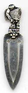 This bookmark was made possibly in Germany. The top is a man carrying a bushel of wheat, standing on the word AUG. It is also marked 1937.