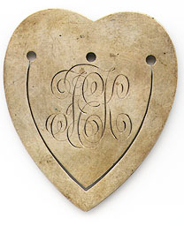 This bookmark was made in the US by Gorham. It is marked with the makers hallmark, sterling and the number 29. It is in the shape of a heart finished in a gold wash. It originally had a large tassel. It is one of 33 bookmarks sold in the Autumn 1888 silver catalog. 