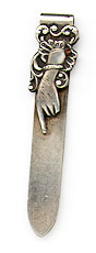 This bookmark was made in the US by Webster Company. It is marked with the makers hallmark and .925 sterling. The top blade is an art nouveau lady's hand pointing her finger. The date is 1900 - 1910.