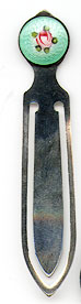 This bookmark was made in the US by an unknown manufacturer. It is marked only sterling. The top is enamel and has a picture of a flower. The date is 1900 - 1910.